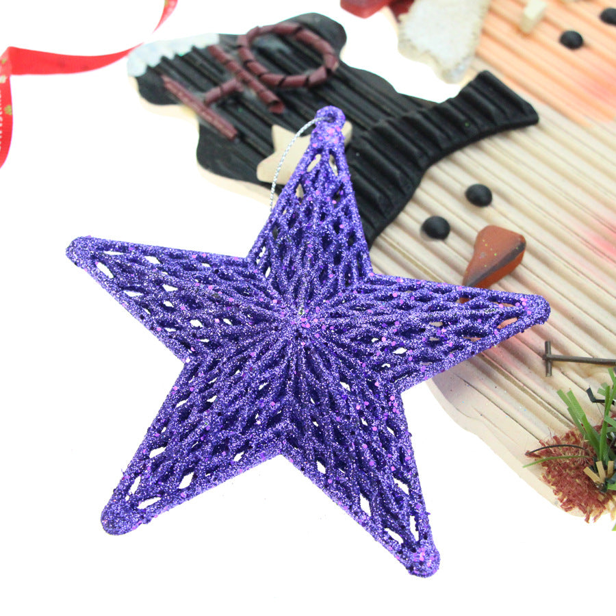 Three-dimensional star ornament with five points displayed on Christmas tree branches