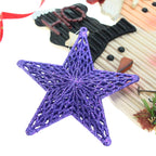 Three-dimensional star ornament with five points displayed on Christmas tree branches