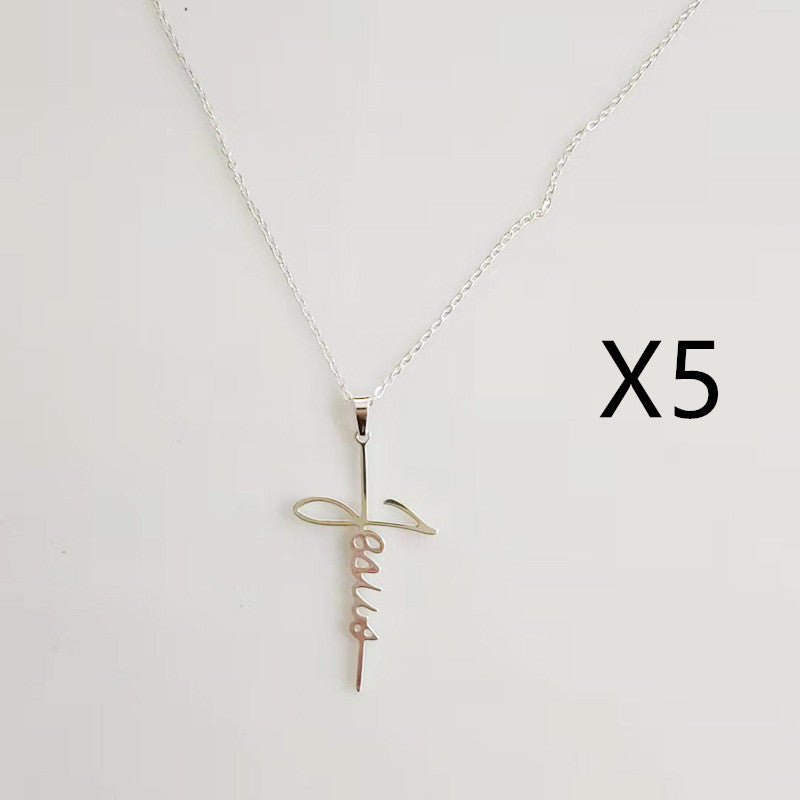 Silver Jesus cross pendant on chain against soft lighting