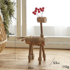 Solid wood deer ornament displayed on Christmas tree branch