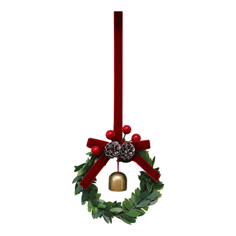 Close-up view of festive bell garland ornament showing pine cone and leaf details