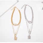 Christian multilayer necklace, embossed detail close-up