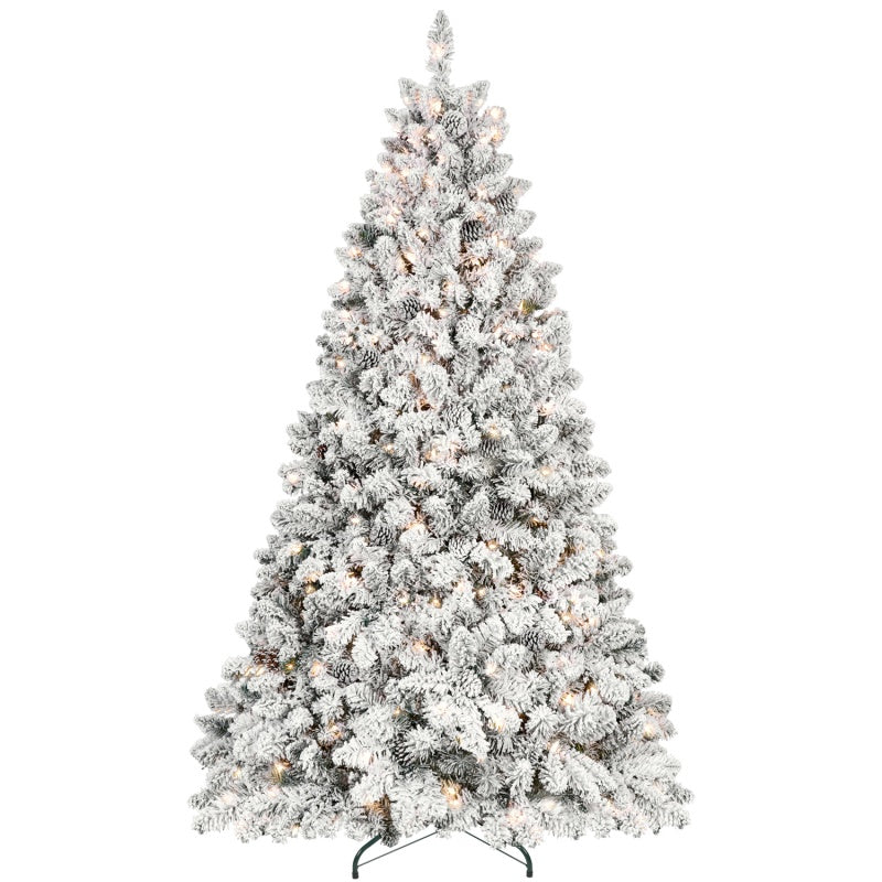 Hand placing star ornament atop flocked Christmas tree