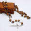 Catholic wooden rosary necklace with red beads and cross pendant for prayer and devotion
