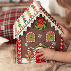 Wooden gingerbread house Christmas decoration displayed as tree ornament