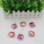 Red peach heart Christmas pendant hanging, displaying the heart shaped ornament design with faith theme