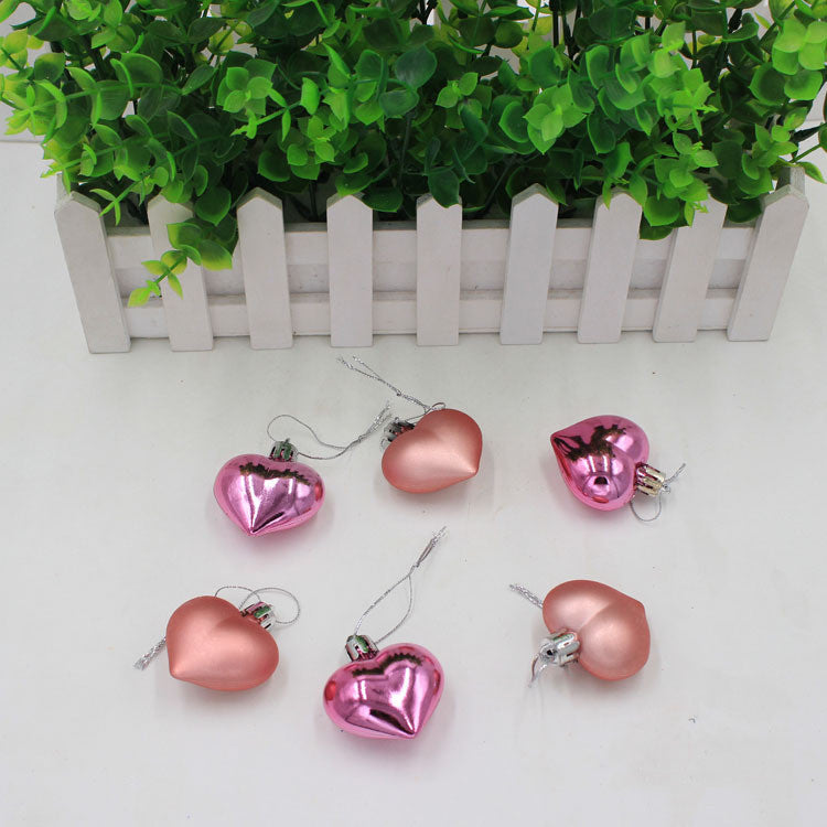 Red peach heart Christmas pendant hanging, displaying the heart shaped ornament design with faith theme