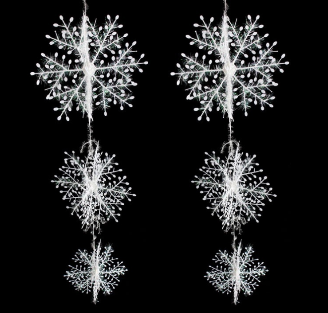 Multiple snowflake string pieces arranged for holiday decoration showcase