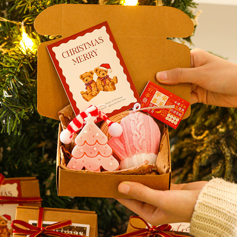 Festive Christmas candle gift box set with holiday decorations and warm glow