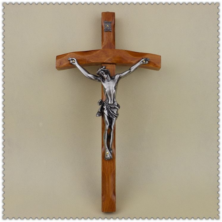 Jesus cross with metal accents displayed as wall decor in a home setting