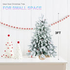 Snow-flocked tabletop Christmas tree with pine cones and red berries for Christian home decor