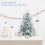 Snow-flocked tabletop Christmas tree with pine cones and red berries for Christian home decor
