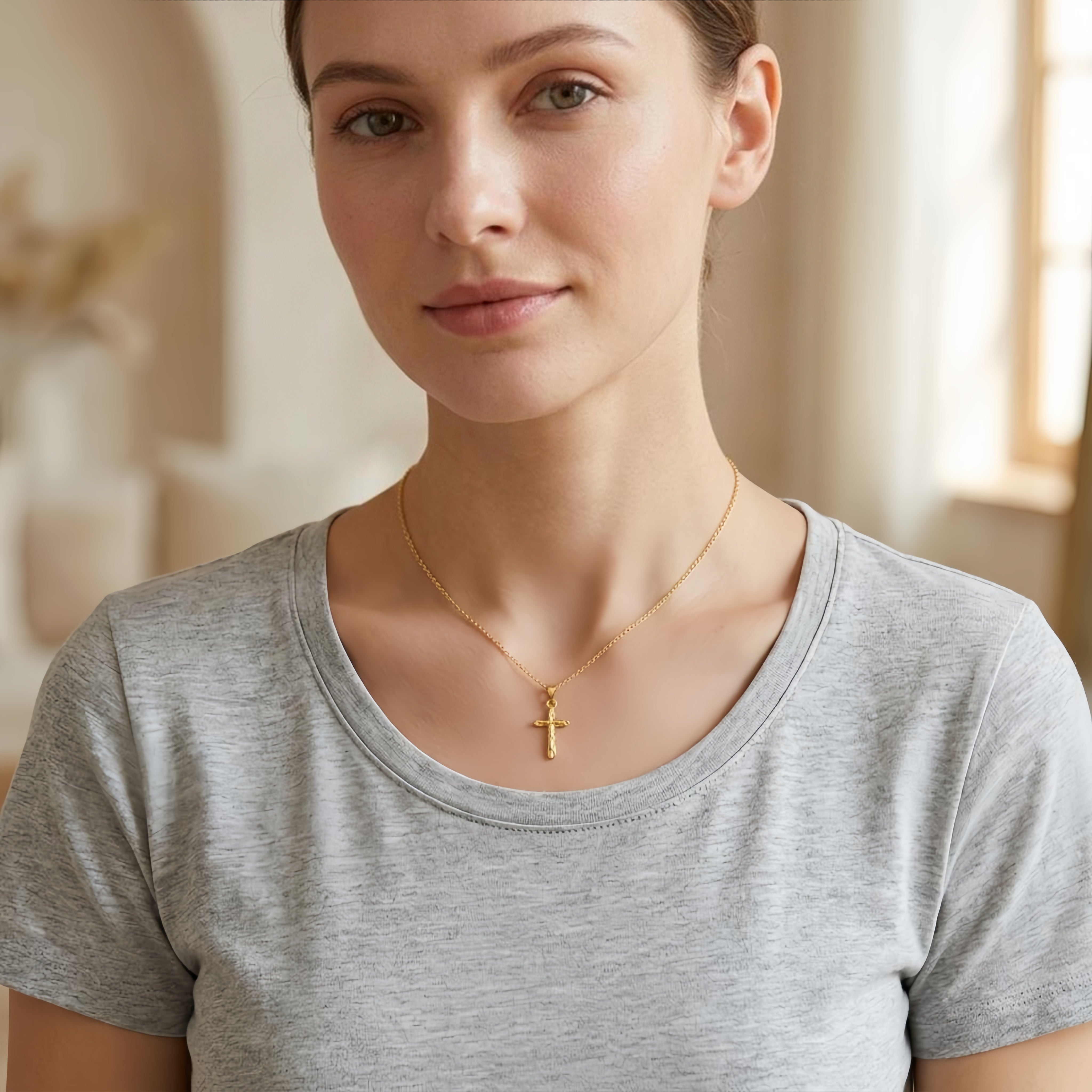Gold cross pendant necklace with textured horizontal ridges on a delicate chain Main image
