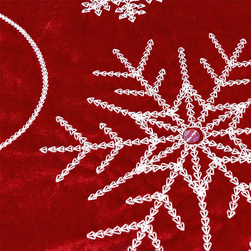 Festive red and white Christmas tree skirt with lace trim detail for holiday decorating