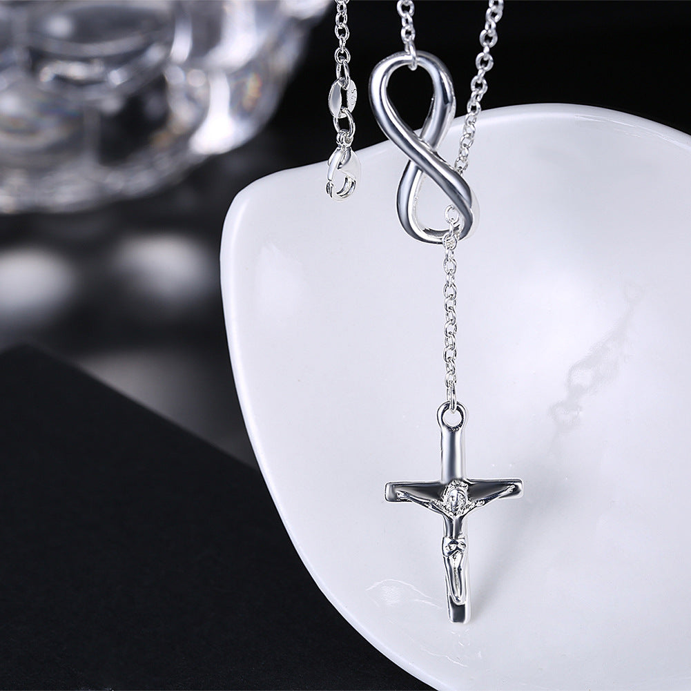 Woman wearing geometric cross pendant necklace