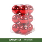 Red electroplated Christmas ornament balls hanging on a tree branch in festive setting
