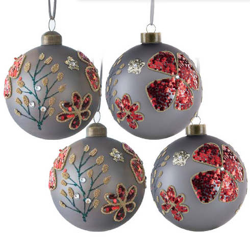 Glass Christmas ball ornaments set displayed on holiday tree branches