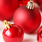 Close-up of glossy red plastic ornament ball with reflective electroplated finish