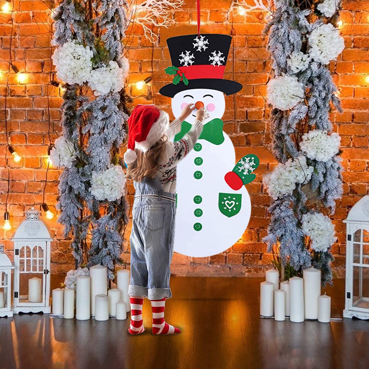Child carefully arranging felt nose pieces on snowman craft project