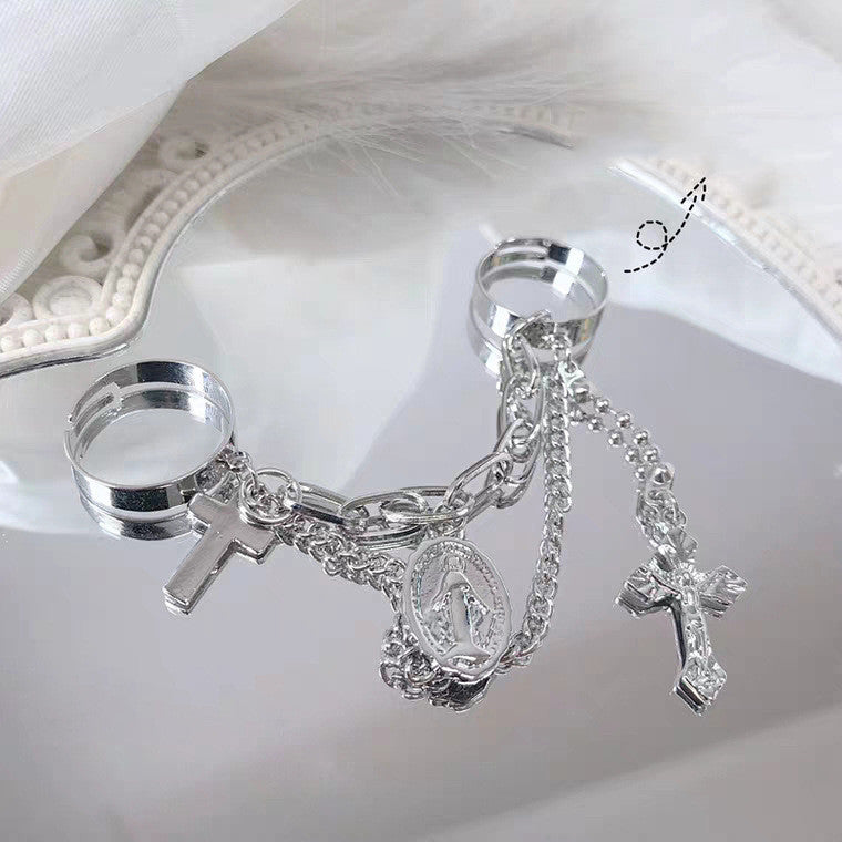 Vintage cross ring worn on two fingers for a stacked look