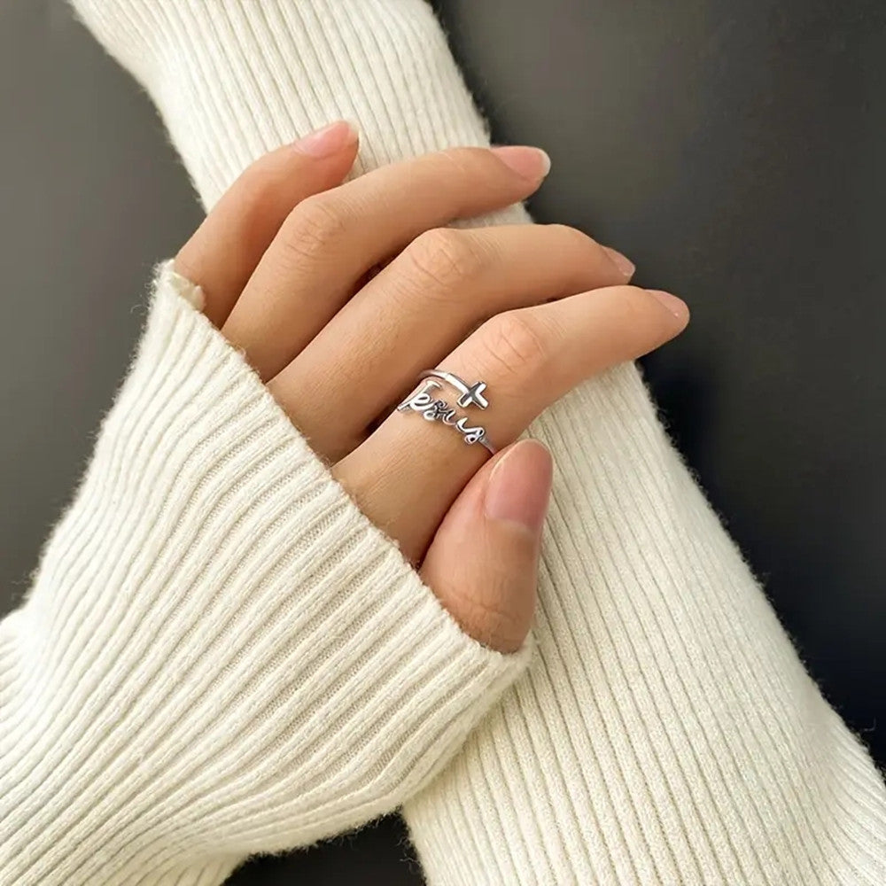Close-up view of electroplated cross and Jesus design on adjustable ring