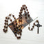 Vintage imitation agate benedict cross necklace with metal chain on dark background faith jewelry