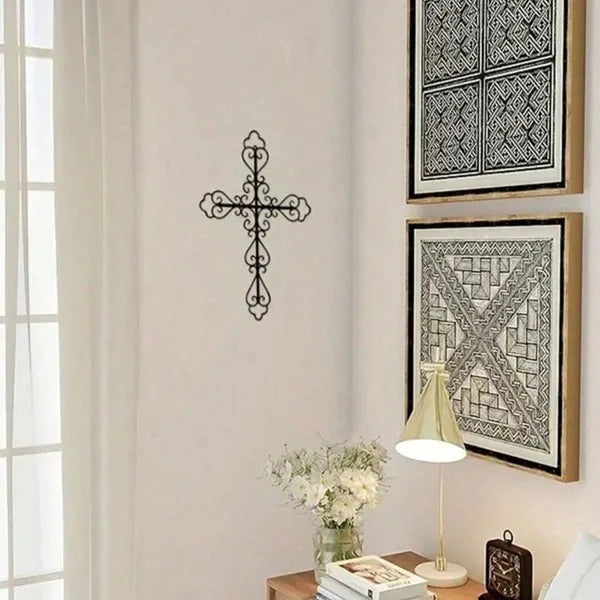 Hollowed scrollwork cross wall art in black metal with pre-drilled mounting holes Main image