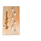 Wooden Christmas pendant hanging from tree branch