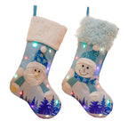 Set of luminous Christmas stockings arranged on a festive holiday mantle