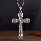 Close-up view of detailed silver cross pendant craftsmanship and shine