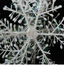 Set of 3D Christmas snowflake string decorations hanging in festive display