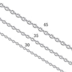 Person wearing simple silver cross pendant necklace