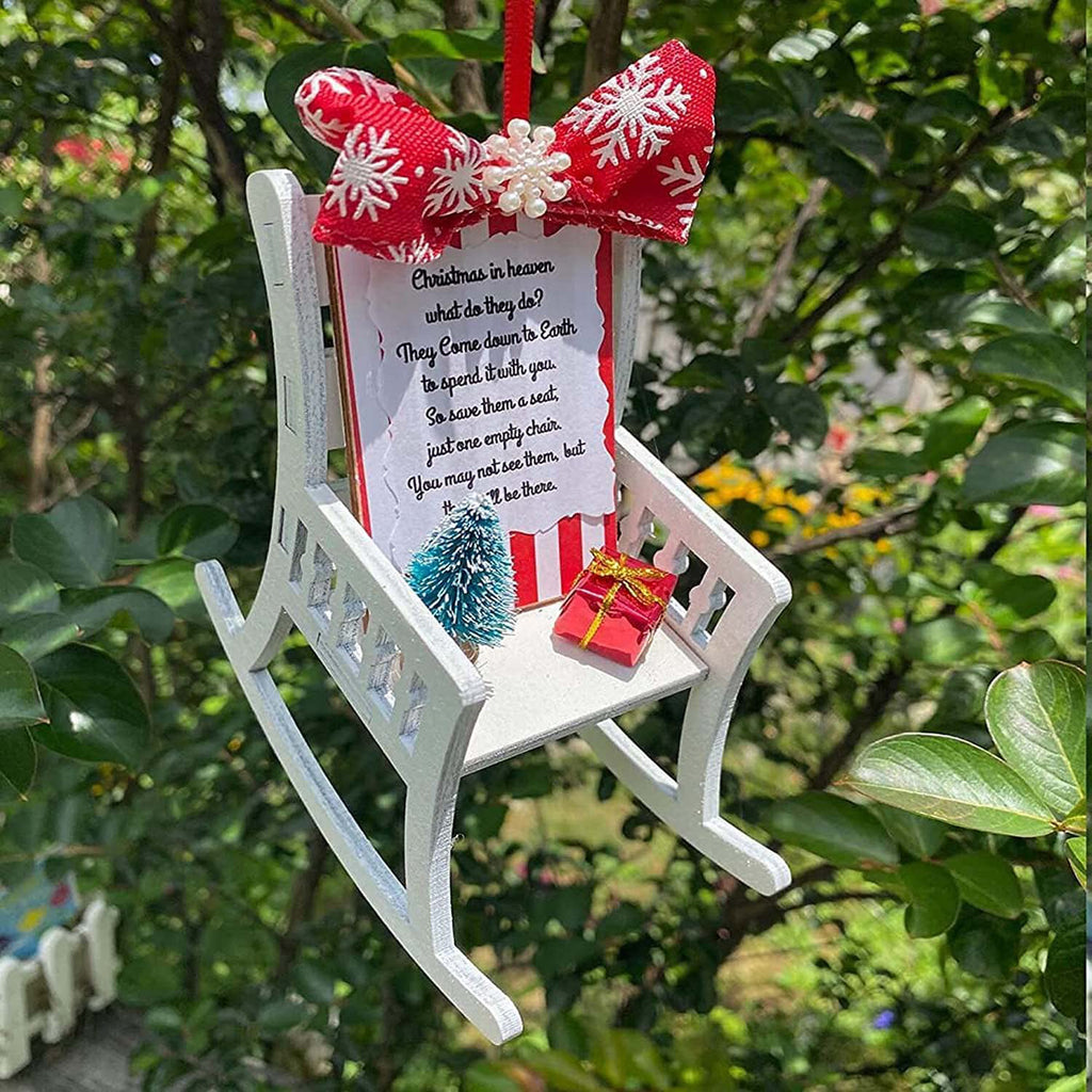 Heaven Chair ornament hanging on decorated Christmas tree in warm setting