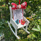 Heaven Chair ornament hanging on decorated Christmas tree in warm setting