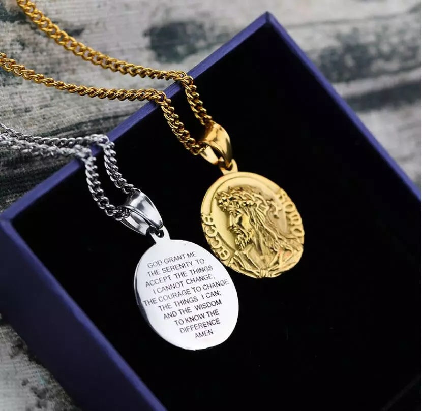 Jesus pendant necklace displayed on white surface with chain detail visible