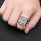 Men's vintage Jesus cross ring displayed at an angle on a dark surface