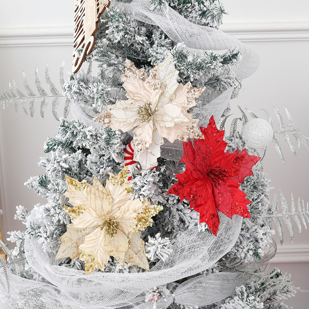 Red glitter Christmas poinsettia arrangement styled with pine branches and berries