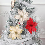 Red glitter Christmas poinsettia arrangement styled with pine branches and berries