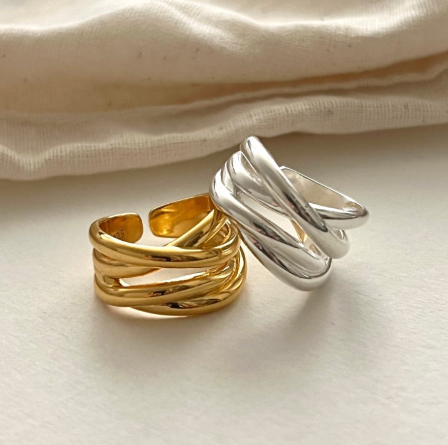 Irregular glossy cross ring on a white marble surface - faith and hope Main image