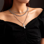 Fashion punk-style layered necklace with Jesus cross pendant on model