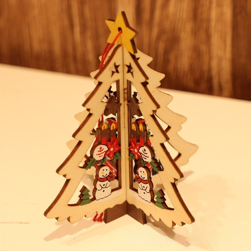Christmas wooden star ornament with five points resting on green branches Main image