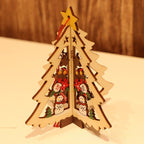 Christmas wooden star ornament with five points resting on green branches