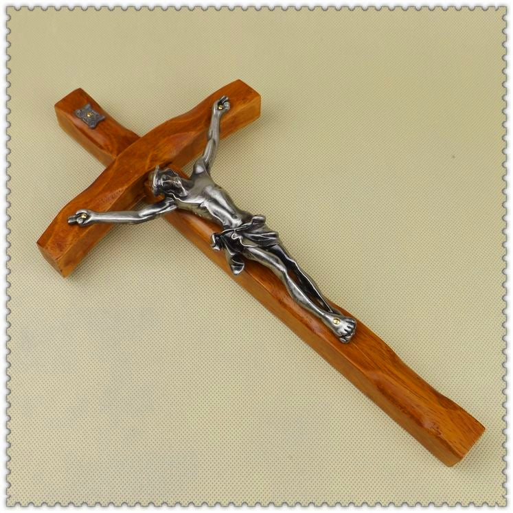 Elegant wall cross combining natural wood grain with metal detailing