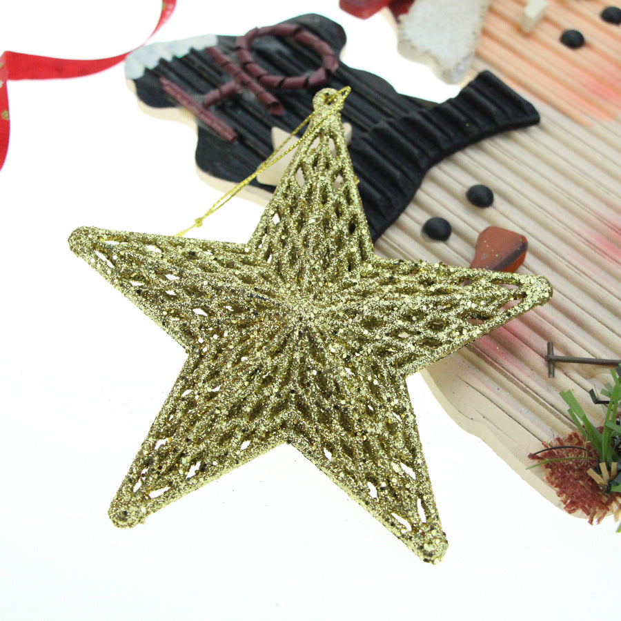 Two plastic star ornaments in gold and silver finish against festive red background