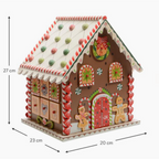 Wooden gingerbread house party decoration for holiday celebrations