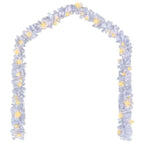 White garland draped along outdoor garden fence with LED glow