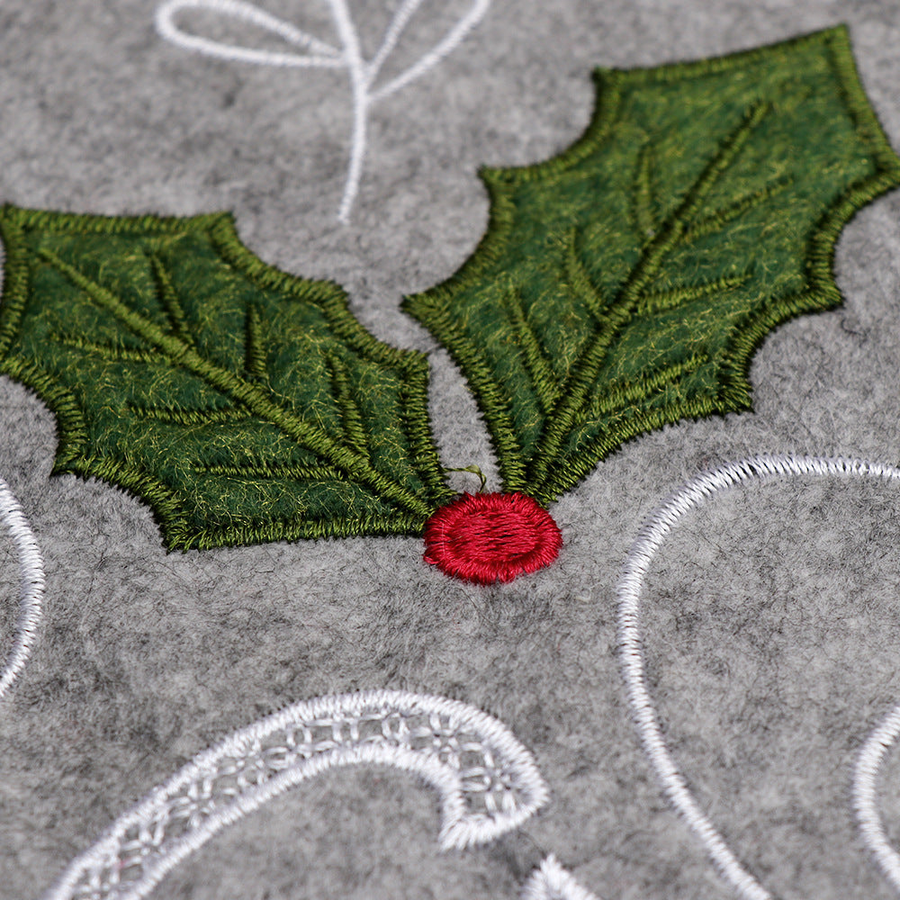 Gray Christmas tree skirt displayed under decorated holiday tree