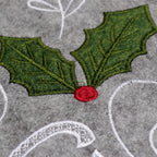 Gray Christmas tree skirt displayed under decorated holiday tree
