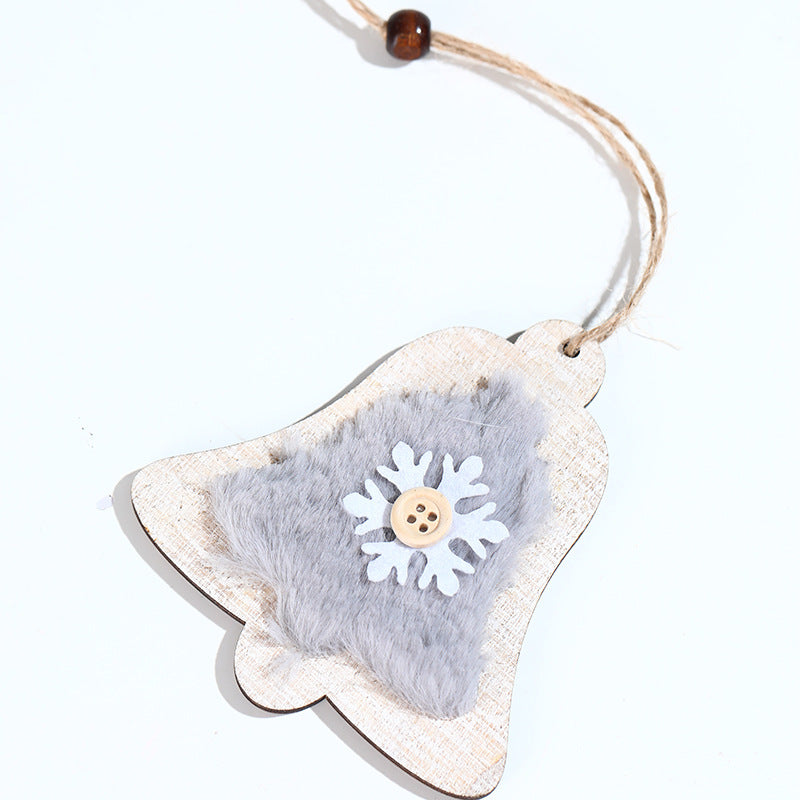 A wooden Christmas tree pendant with plush detailing hangs ready to bring festive warmth to your home