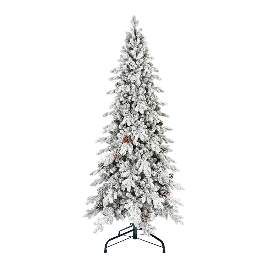 Flocked Christmas tree with warm lighting in home interior